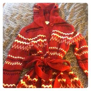 Long button up sweater with hood and a waist tie.